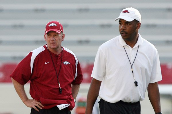 Garrick McGee (at right) shown with former Arkansas Razorbacks Coach Bobby Petrino in 2010, is not a candidate to become the next head coach. He took the head coaching job at Alabama-Birmingham on Dec. 3 and is going through his first spring with the Blazers. 