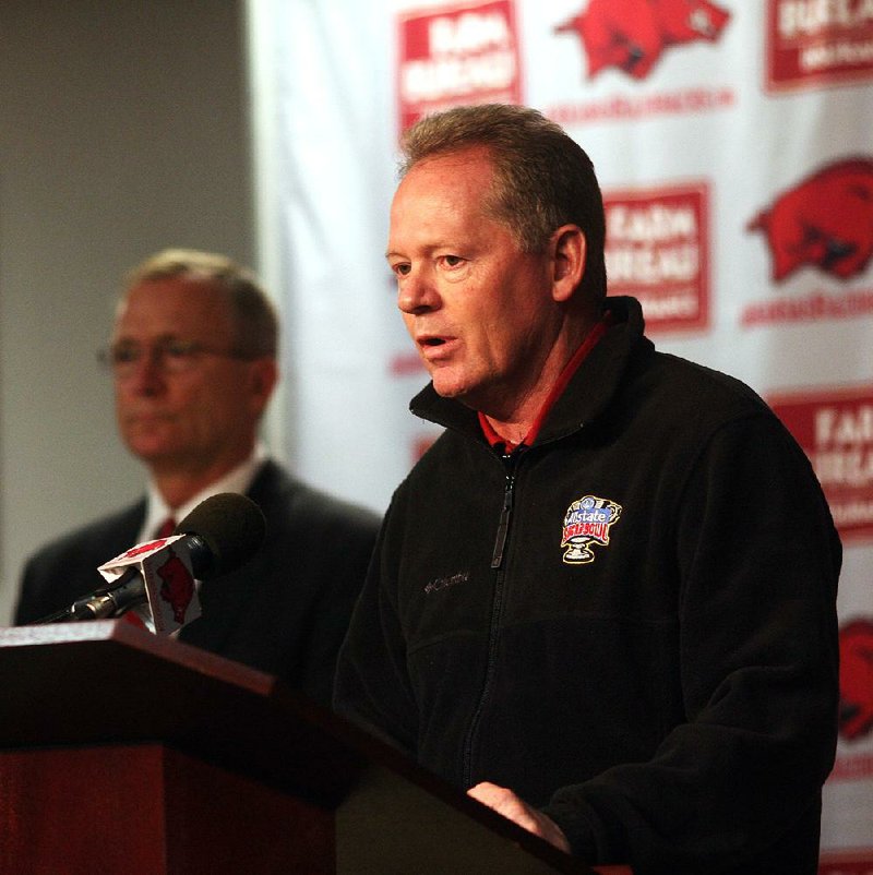 Former football Coach Bobby Petrino is shown last year with Athletic Director Jeff Long (left) at the Broyles Athletic Center on campus in Fayetteville.