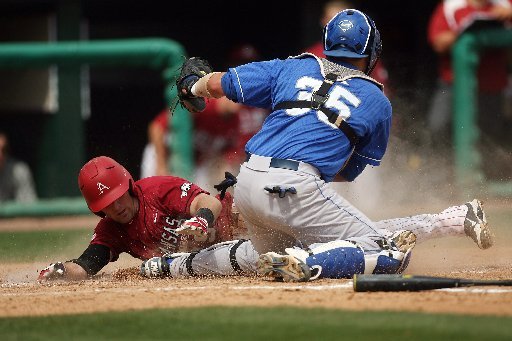 Arkansas Democrat-Gazette/WILLIAM MOORE -- Arkansas' Jake Wise is tagged out at home by Kentucky catcher Michael Williams Saturday, April 14, 2012 at Baum Stadium in Fayetteville.