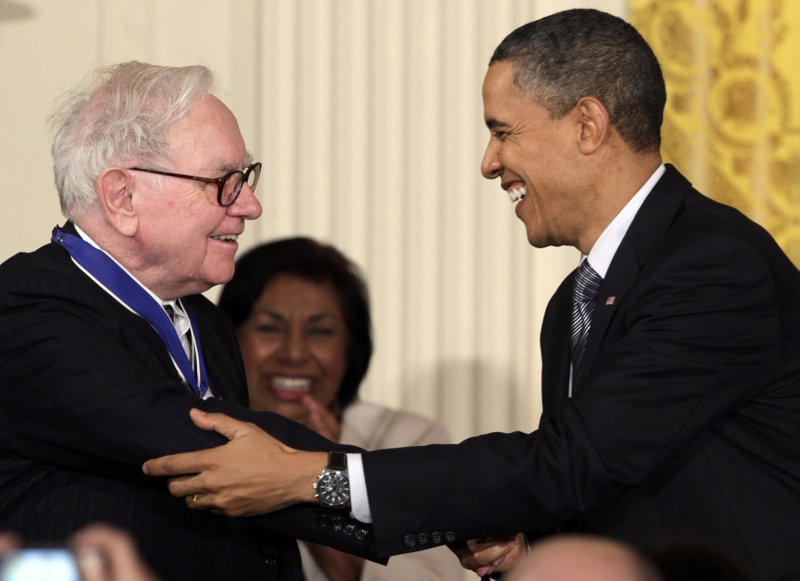 In this Feb. 15, 2010, file photo President Barack Obama congratulates Warren Buffett after presenting him with a 2010 Presidential Medal of Freedom in an East Room ceremony at the White House in Washington. In his weekly radio and internet address Saturday April 14, 2012, Obama urged Americans to ask their member of Congress to support the "Buffett Rule," named after the billionaire investor who says he pays a lower tax rate than his secretary. Obama says the nation can't afford to keep giving tax cuts to the wealthiest, "who don't need them and didn't even ask for them." 