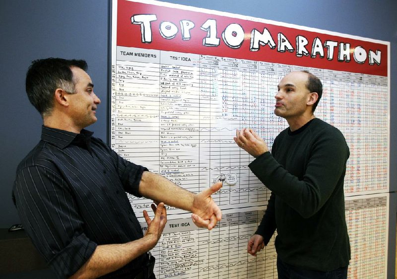 Netflix executives John Ciancutti (left) and Todd Yellin chat last month by an idea board at Netflix headquarters in Los Gatos, Calif. 