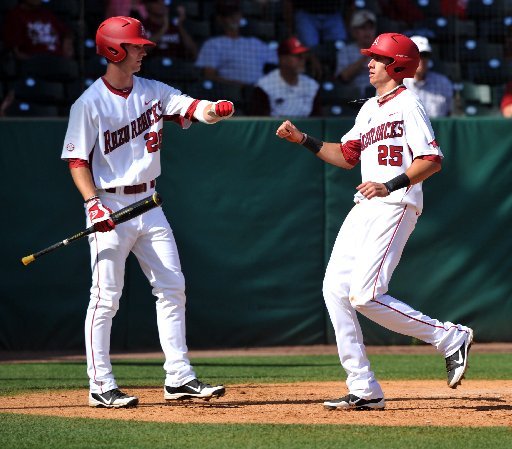 Arkansas Democrat-Gazette/MICHAEL WOODS - 04/17/2012 - Arkansas first baseman Dominic Ficociello is greeted by teammate Conor Costello after scoring a run in the fourth inning of Tuesday afternoon's game against Stephen F. Austin at Baum Stadium in Fayetteville.
