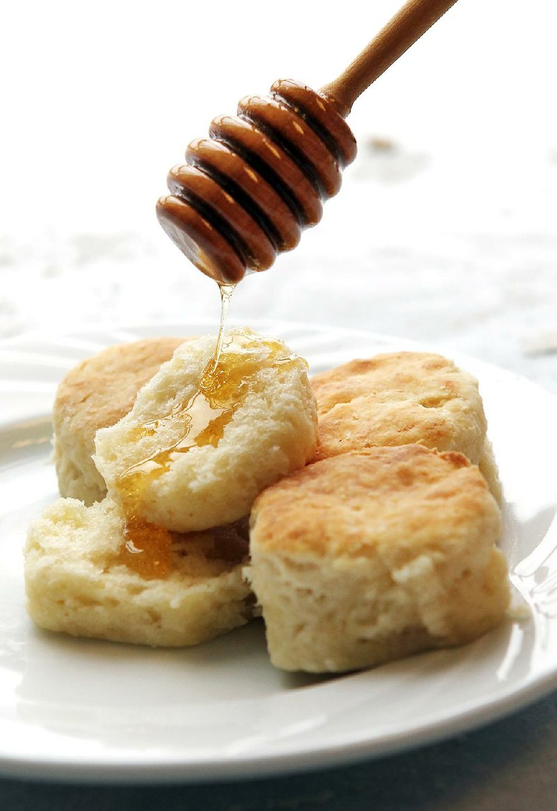 Callie’s Charleston Biscuits, served here with a drizzle of honey, can be baked ahead and frozen. 