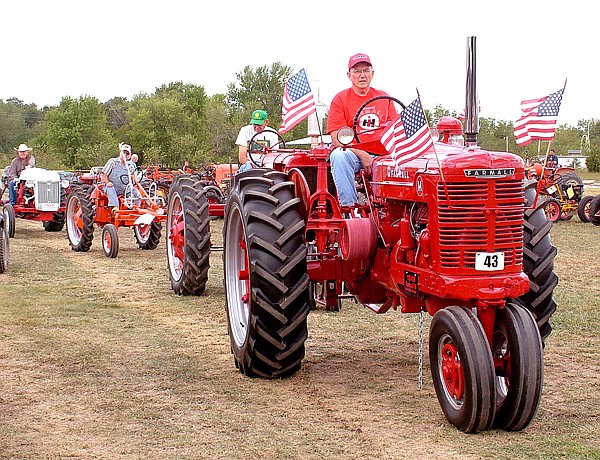 Don Hevener, on his 1948 Farmall tractor, leads a group of tractors — Don Gilbert, followed by Gene Wietzel on the G Allis Chalmers — by the bleachers during the Parade of Power held during the fall show in September of 2011. The 20th annual Spring Crank-up will begin on Friday at the Tired Iron showgrounds on Taylor Orchard Road south of Gentry.