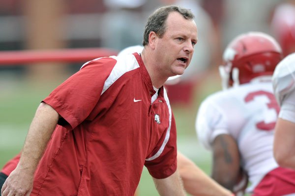 University of Arkansas Tim Horton works with the team during Friday afternoons practice at Razorback Stadium.
