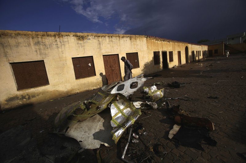 A Pakistani man walks by the wreckage of a Bhoja Air Boeing 737 passenger plane that crashed on Friday, killing all 127 people on board, on the outskirts of Islamabad, Pakistan, Sunday, April 22, 2012. Pakistan barred the head of the airline whose jet crashed near the capital from leaving the country, vowing to investigate the tragedy that revived fears about the safety of aviation in the country saddled by massive economic problems. 