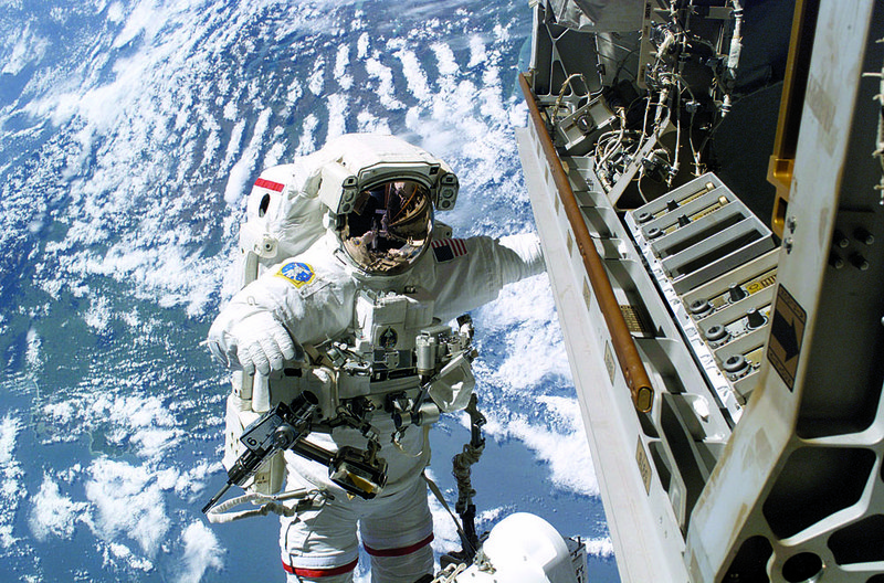Astronaut Robert Curbeam prepares to replace a faulty TV camera on the exterior of the International Space Station in December 2006. 