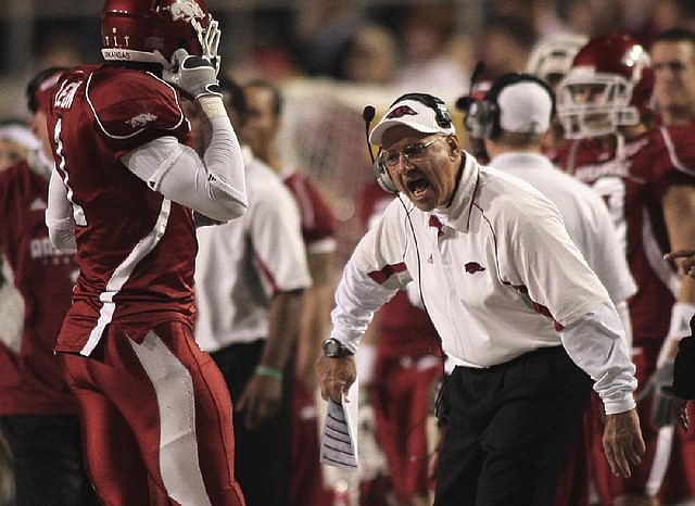 Arkansas assistant coach John L. Smith yells plays to his players during the Razorbacks’ game against Troy in November 2009.