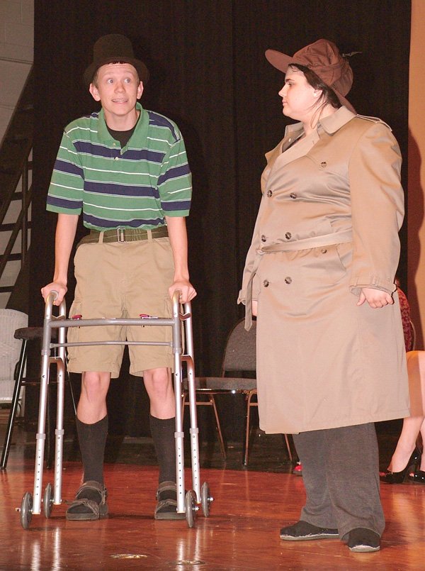 Brandon Brigance, playing a decrepit invalid, is questioned by the inspector, Emily Bond, during rehearsal for the upcoming performance of "Murder in the Knife Room," to be performed by drama students at Gentry High School on April 26.