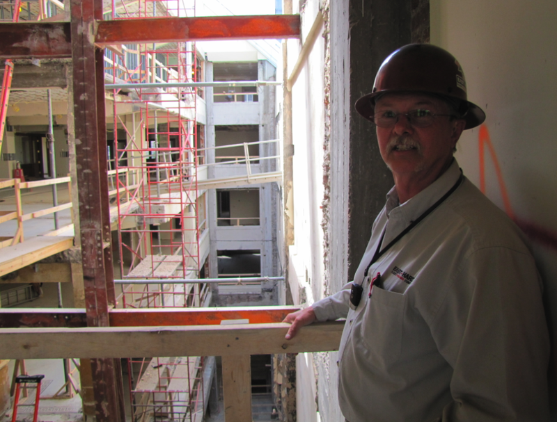 John Newkirk, construction superintendent with East Harding Construction, leads a tour on a major renovation of the Exchange Bank Building in downtown Little Rock.