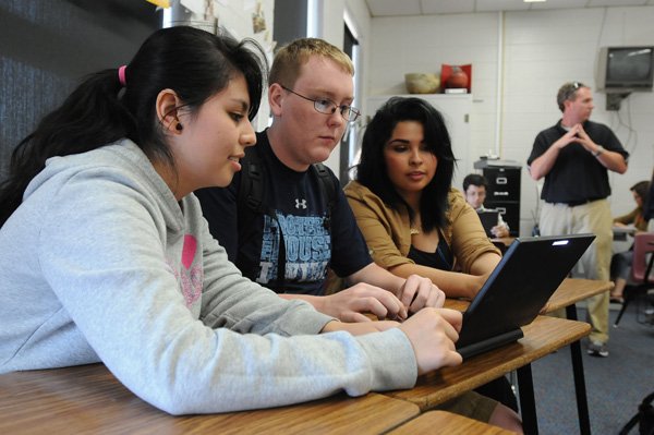 Barbara Martinez, 16, from left, Clinton McCarver, 18, and Kiara Zapete, 17, all Springdale High School juniors, work on a project Wednesday in Scottie Person’s world history class. The students will use net books to view and create their projects which will touch on all subjects they have studied this year. 