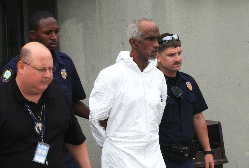 FILE - Police walk Michael David Sadler, Sr., (second from right) to a waiting patrol car after charging him with one count on 1st degree murder on May 3, 2012.