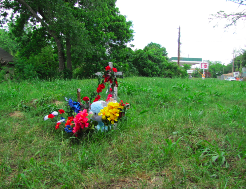A small memorial stands for Michael Stanley Jr. in the grassy lot where he was struck by a van and beaten after a chase.