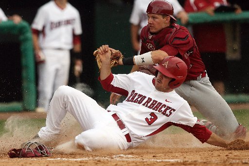 Arkansas Democrat-Gazette/WILLIAM MOORE -- Arkansas' Jacob Mahan is tagged out at home by South Carolina catcher Grayson Greiner Sunday, May 6, 2012 at Baum Stadium in Fayetteville.