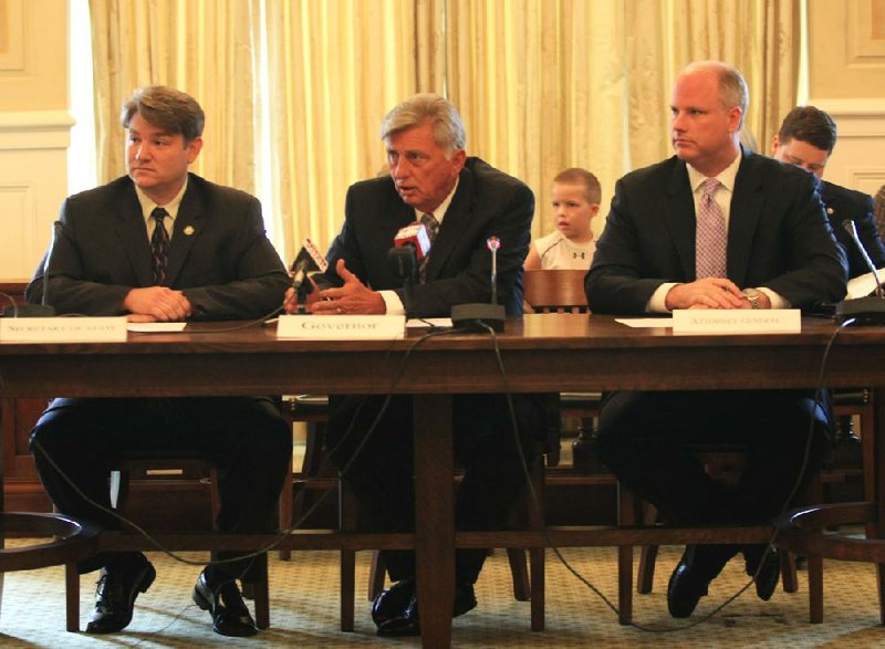 FILE - Gov. Mike Beebe, center, speaks at a July 29, 2011 state Board of Apportionment meeting with fellow board members Secretary of State Mark Martin, left, and Attorney General Dustin McDaniel Friday at the state Capitol.


