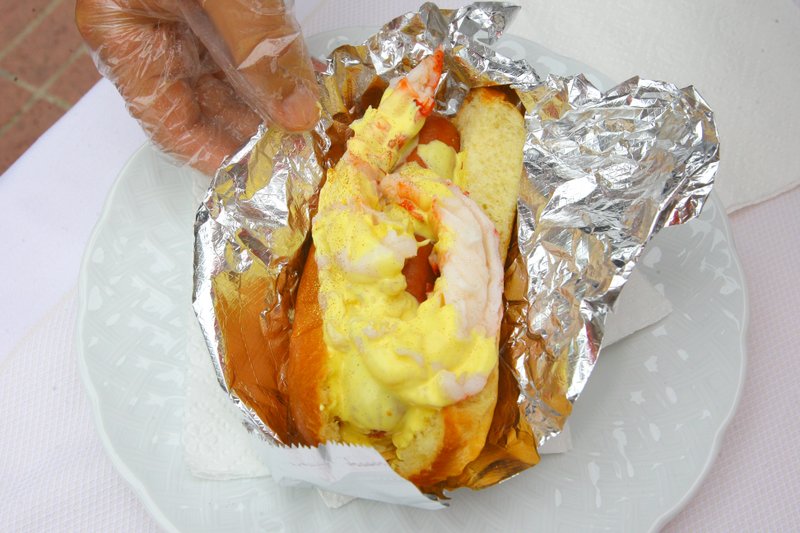 Gold-dusted, lobster-topped hot dogs sold for  $1501 each to benefit the One, a non-profit that provides aid to local homeless people, downtown today. 