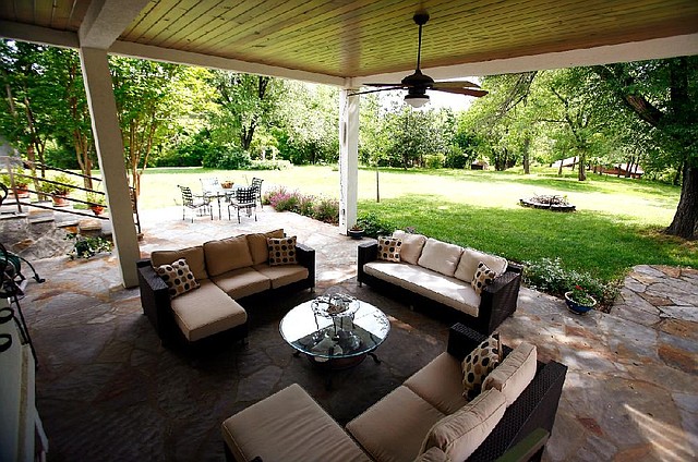 The comfortable outdoor room at Julie Fryauf’s home has ample seating and easy access to the outdoors, with the advantage of ready protection from sun and rain. 