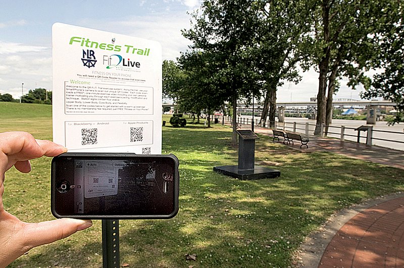 The first of six QR F.I.T. Trail system signs stands beside the River Trail near the Willow Street gate. 