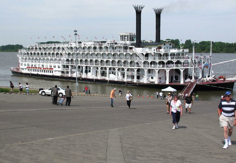 In this April 30, 2012 photo, passengers disembark the American Queen steamboat in Henderson, Ky. The American Queen is the largest steamboat in the world, carrying 436 passengers. (AP Photo/Adrian Sainz)