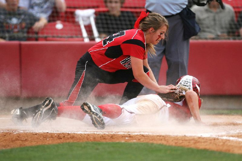 White Hall pitcher Sydnee Clark attempts to tag out Vilonia’s Ashley Lyons at home plate during the second inning of Saturday’s Class 5A state softball championship game at Bogle Park in Fayetteville. White Hall defeated Vilonia 5-2. 