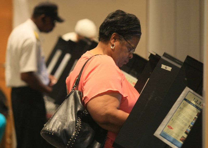 Muriel Thomas of Little Rock votes on the last day of early voting before today’s primary elections.Thomas was one of more than 500 people who voted Monday, according to the Pulaski County Election Commission. 