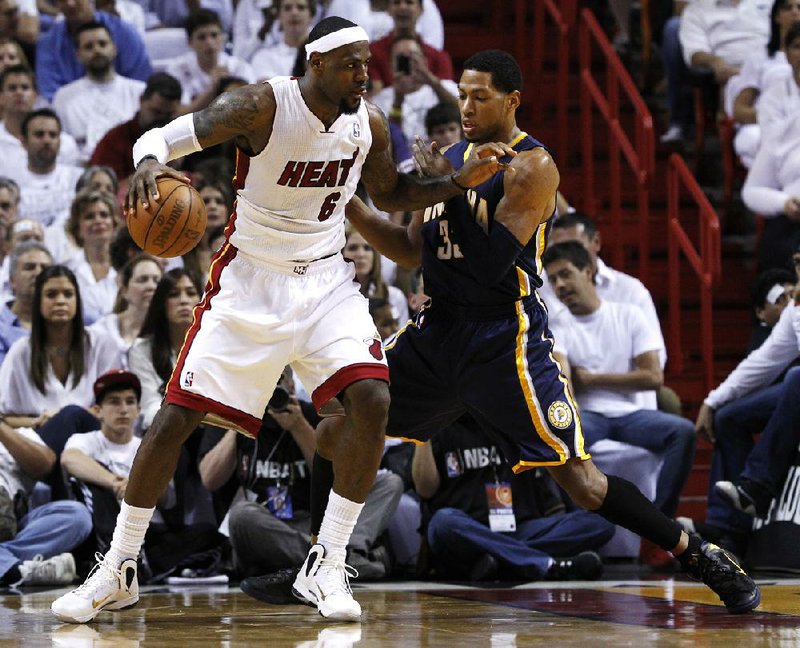 Miami’s LeBron James (6) drives to the basket as Indiana’s Danny Granger defends during the first half of the Heat’s 115-83 victory Tuesday in Miami. James scored 30 points and grabbed eight rebounds as the Heat took a 3-2 lead in their NBA Eastern Conference semifinal. 