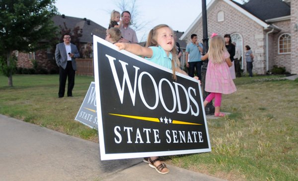 Johannah Duggar, 6, attempts to move a sign supporting Rep. Jon Woods during a watch party Tuesday, May 22, 2012, in Fayetteville. Woods was running against Sen. Bill Pritchard for the district seven state senate seat.
