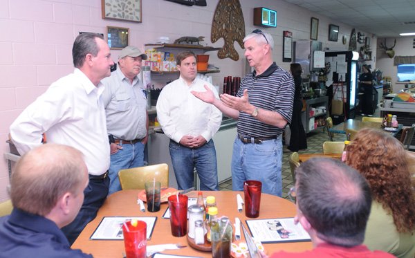 Third District Rep. Steve Womack, right center, speaks Wednesday with Rep. Jon Woods, center, and Woods’ supporters at Neal’s Cafe in Springdale where Woods met for lunch with supporters and constituents after Tuesday’s win over Sen. Bill Pritchard of Elkins.