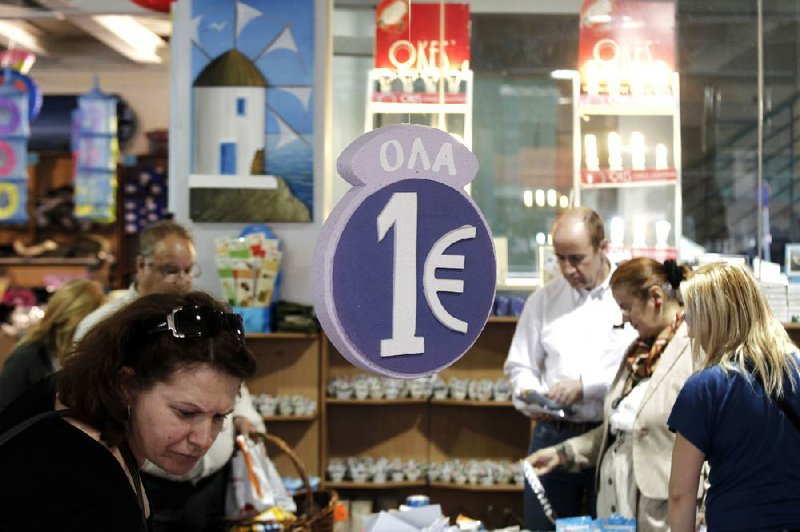 Customers browse discounted goods for sale at a one-euro store in Athens on Thursday. European leaders tied their next steps on the financial crisis to the outcome of a bitterly contested election in Greece that may determine whether the 17-nation euro currency splinters. 