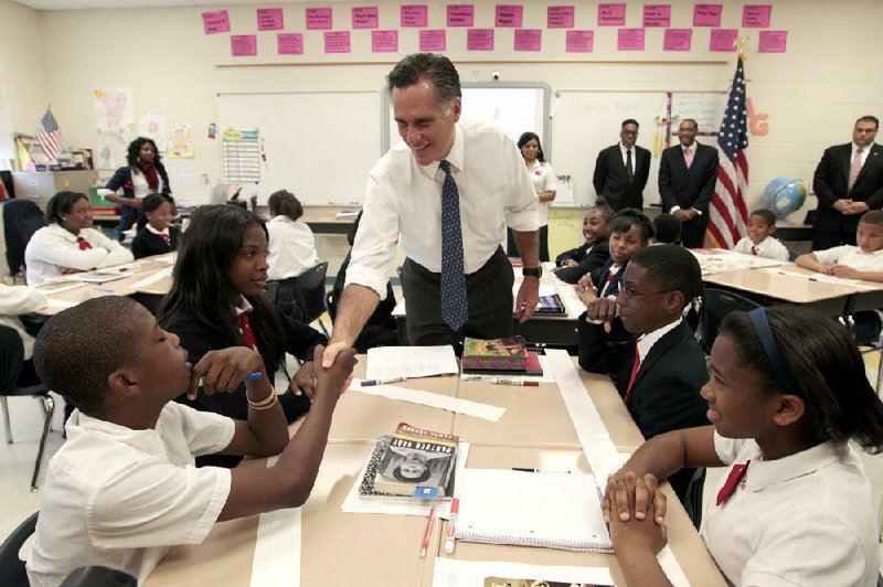 Republican presidential candidate Mitt Romney greets Justic Green during a tour Thursday of the sixth-grade language-arts class at the Universal Bluford Charter School in Philadelphia. 