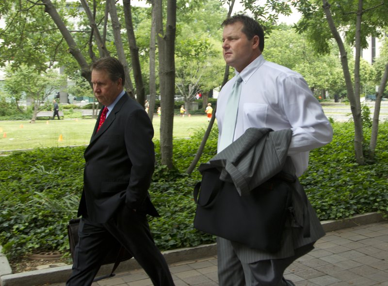 Former Major League Baseball pitcher Roger Clemens, right, arrives at federal court in Washington, Wednesday, May 23, 2012.