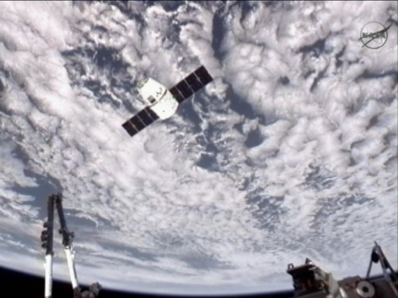This image provided by NASA-TV shows the SpaceX Dragon commercial cargo craft, top, as Dragon approaches the International Space Station, Friday, May 25, 2012. Dragon is scheduled to spend about a week docked with the station before returning to Earth on May 31 for retrieval.
