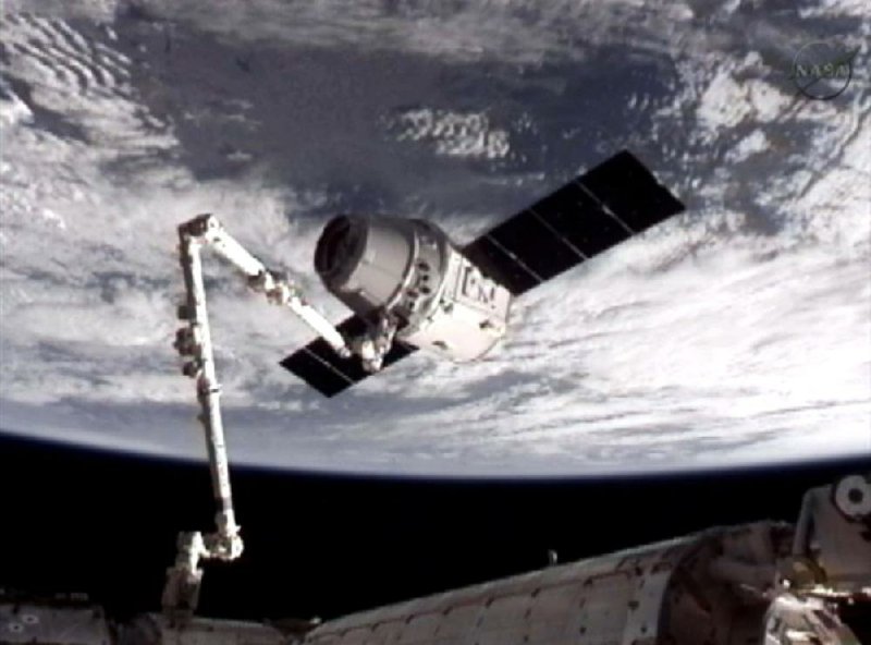 Snared by the International Space Station’s 58-foot robot arm, SpaceX’s Dragon capsule successfully docked with the orbiting outpost Friday. The docking was the first time a commercial enterprise has delivered supplies to the station. The next task for SpaceX is to get the capsule home intact.