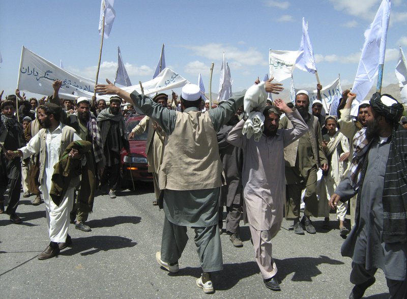 More than 1,500 Afghans block the highway between Kabul and Kandahar in Seed Abad, Wardak province, Afghanistan, Saturday, May 26, 2012. The protesters demanded a stop to military night operations.