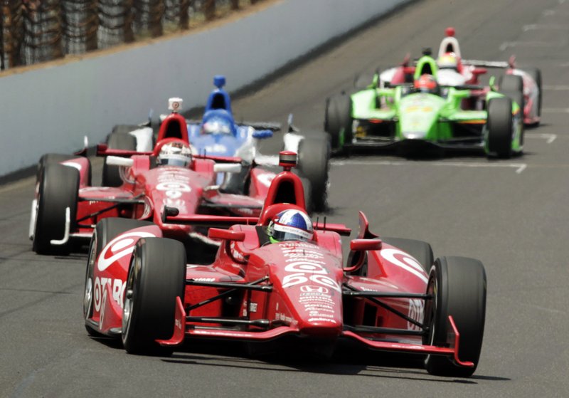 Dario Franchitti, of Scotland, leads teammate Scott Dixon, center, of New Zealand, and Takuma Sato, of Japan, into the first turn during IndyCar's Indianapolis 500 auto race at Indianapolis Motor Speedway in Indianapolis, Sunday, May 27, 2012. 