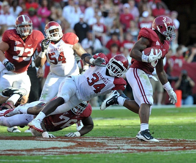 Alabama running back Trent Richardson (3) slips past Arkansas linebacker Jerry Franklin (34) this past September at Bryant-Denny Stadium in Tuscaloosa, Alabama. Beating Alabama has turned into a hassle for the Hogs since Nick Saban took over as the Crimson Tide’s coach in 2007. 