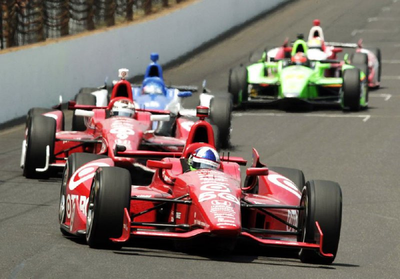 Scottish driver Dario Franchitti (front) leads Chip Gannassi teammate Scott Dixon of New Zealand, and Japanese driver Takuma Sato, into the first turn during the Indianapolis 500 at Indianapolis Motor Speedway on Sunday in Indianapolis. 