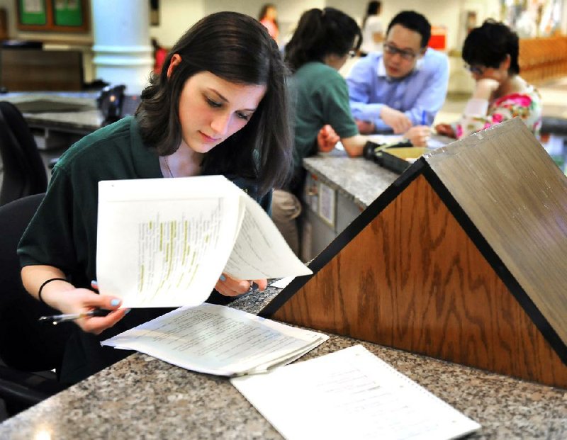 George Mason University sophomore Ashley Dixon studies while working at an information desk on campus in Fairfax, Va. 