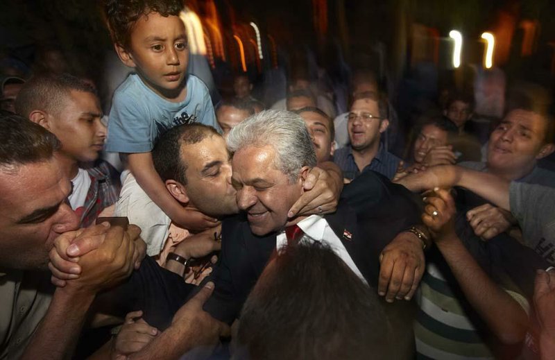 Supporters surround Hamdeen Sabahi outside his Cairo campaign headquarters Saturday. He finished third in Egypt’s presidential election and is challenging the election results. 