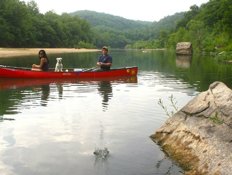 Blake Rhone of Hazen, right, tries to entice a smallmouth bass to bite last Sunday while fishing with Alexandra Lewis of Hope. 