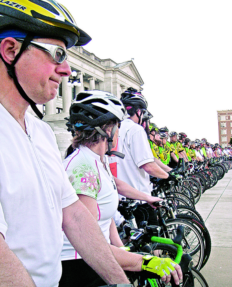 Jim Britt stands with fellow bike advocates below the steps of the state Capitol at sunset May 16 during the annual Ride of Silence, a memorial for all bicyclists killed or injured in traffic accidents. Each rider carried the name of one of more than 50 Arkansans killed in traffic accidents since 1985. 