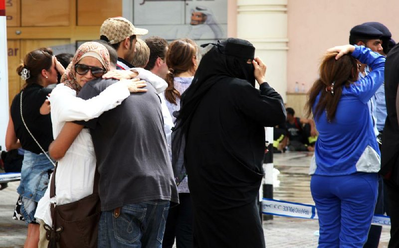 Family members of victims of a fire react Monday after a blaze took hold of the Villaggio Mall in the western end of the Qatari capital of Doha on Monday. 