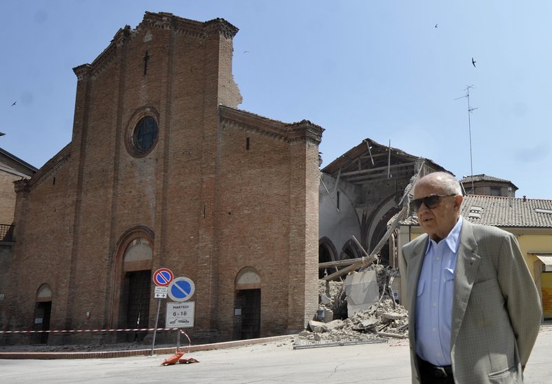 A man walks in front of a collapsed church in Mirandola, northern Italy, Tuesday, May 29, 2012. A magnitude 5.8 earthquake struck the same area of northern Italy stricken by another fatal tremor on May 20.