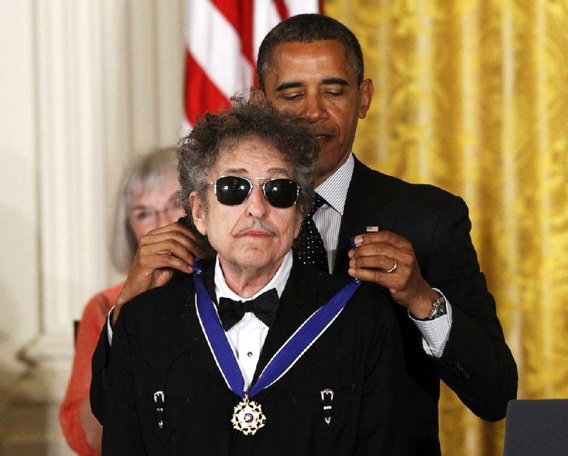 President Barack Obama presents rock legend Bob Dylan with a Medal of Freedom on Tuesday at the White House. 
