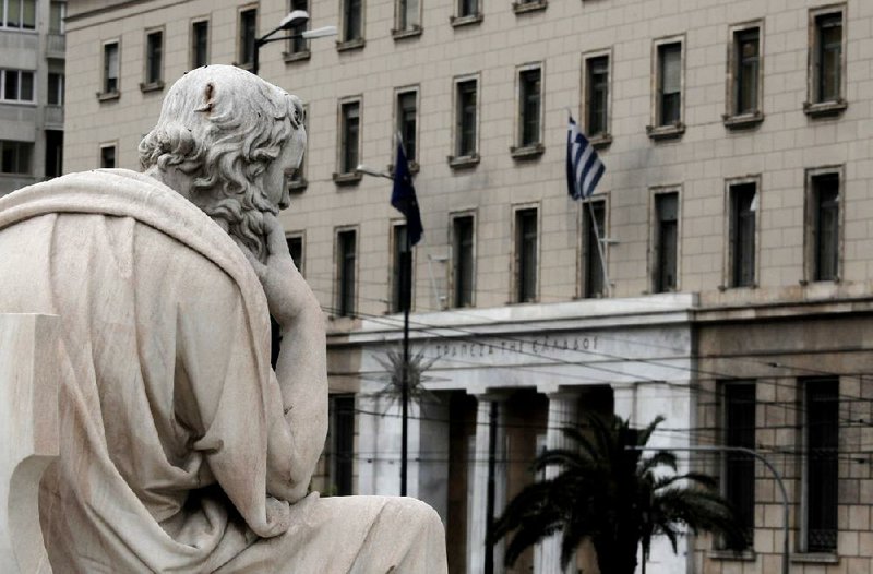 A report from the Bank of Greece, whose headquarters is shown above in Athens, says an exit from the euro could cost Greeks more than half their annual incomes. 