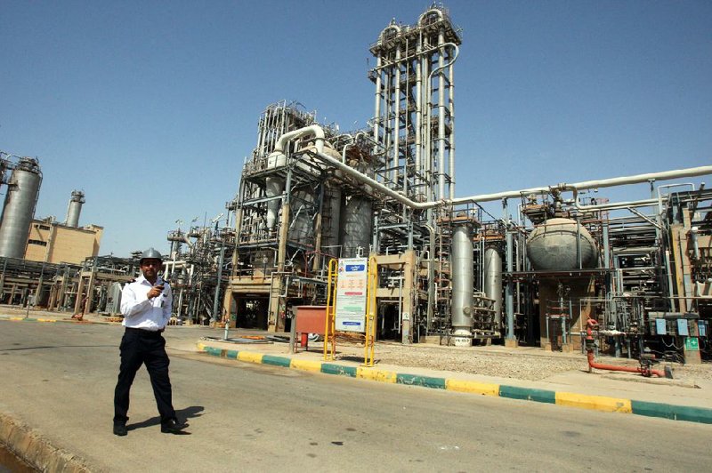 In this Wednesday, Sept. 28, 2011 file photo, an Iranian security guard stands at the Maroun Petrochemical plant at the Imam Khomeini port, southwestern Iran. Technicians battling a complex computer virus took the ultimate firewall measures shutting off all Internet links to Iran's oil ministry and the terminal that carries nearly all the country's crude exports. 
