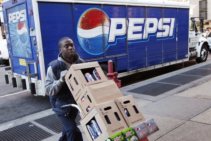 Kandral McKenzie delivers Pepsi products, Thursday, Feb. 9, 2012 in New York in this file photo. PepsiCo is expected to reach an agreement to be the exclusive non-alcoholic cold beverage provider for the University of Arkansas.