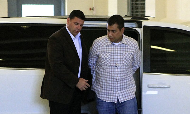 After his bond was revoked, George Zimmerman, right, returns to the John E. Polk Correctional Facility in Sanford, Fla., Sunday, June 3, 2012. Zimmerman is charged with second-degree murder in the shooting of Trayvon Martin.