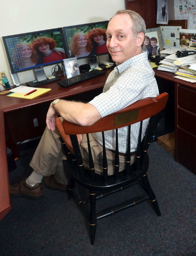 Robert Costrell sits in the chair that was given to him by Mitt Romney while Costrell was education adviser to the former Massachusetts governor from 2005-06. Costrell, endowed chair in education accountability at the University of Arkansas at Fayetteville, is part of an education advisory team for Romney’s presidential campaign.