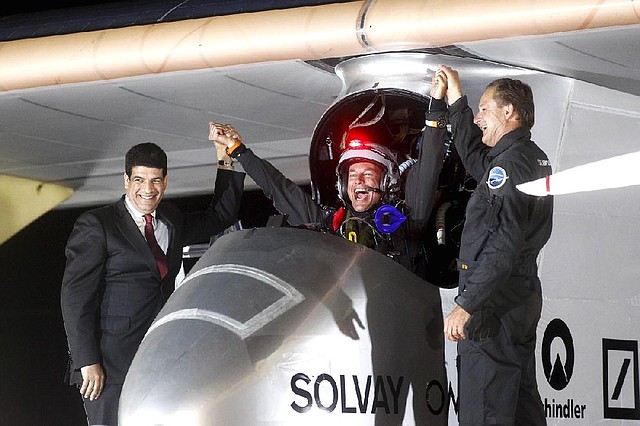 Solar Impulse’s Bertrand Piccard (center) celebrates with fellow pilot Andre Borschberg (right) and Mustafa Bakkouri, president of the Moroccan Agency for Solar Energy, upon the solar plane’s arrival last week at Rabat airport in Morocco. 